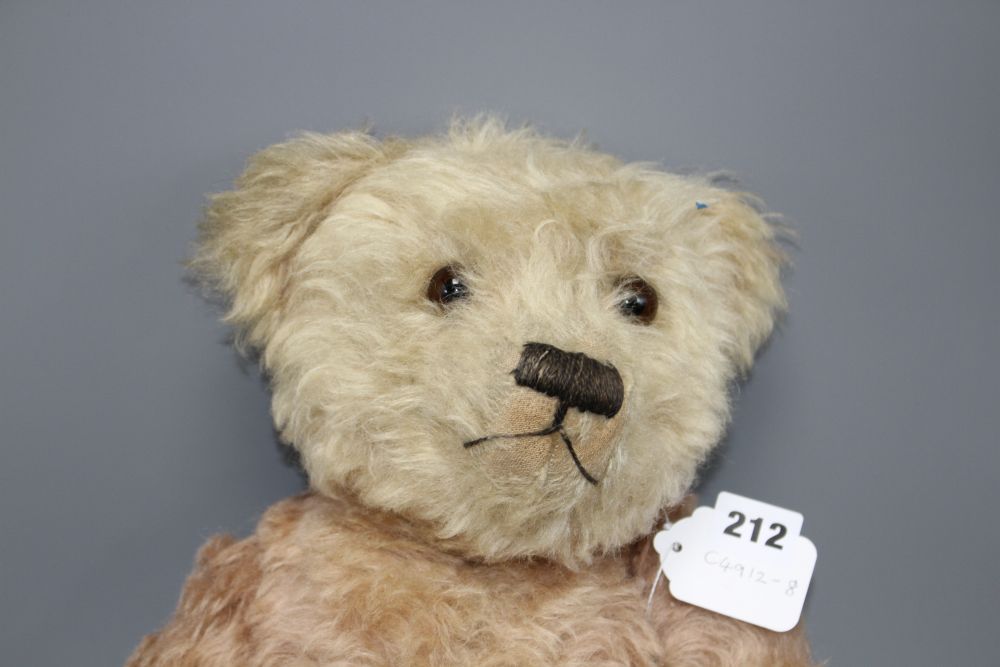 A c.1930s bear, possibly Farnell, 22in., faded pink mohair, original paw pads, good condition except faded head, 22in.